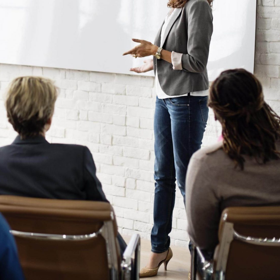 Woman leading workshops in a work environment.